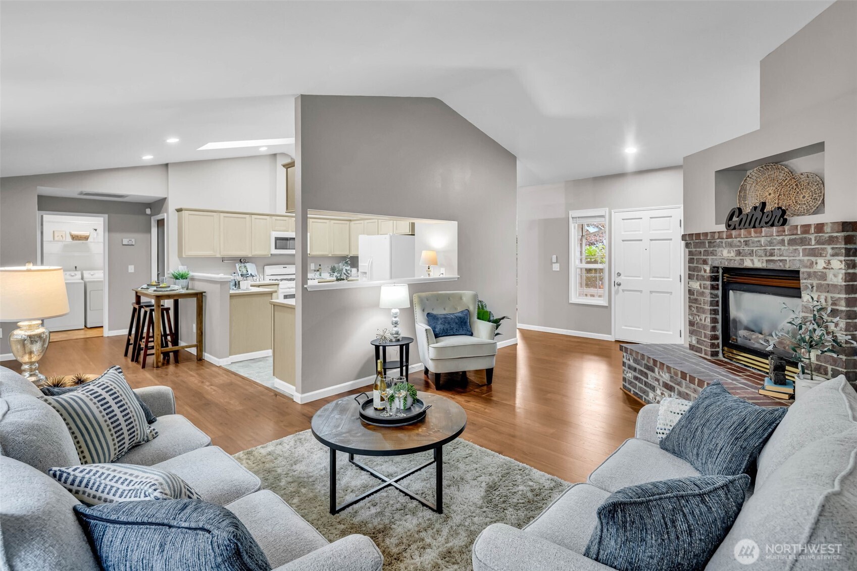 3212 200th Place Southeast Bothell, WA 98012 - Photo 7 of 40 a living room with furniture kitchen view and a wooden floor