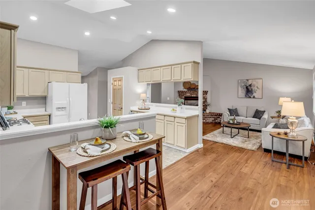 a living room with kitchen island furniture and a wooden floor
