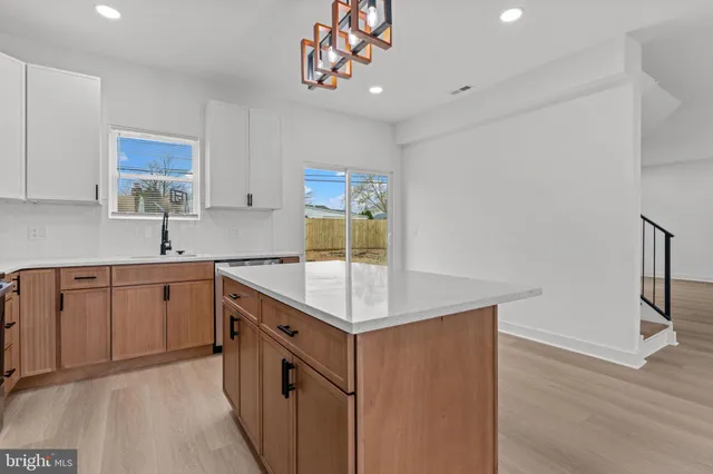 a kitchen with a sink a counter space and cabinets