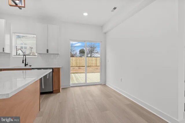 a view of a kitchen with a sink cabinet and a window