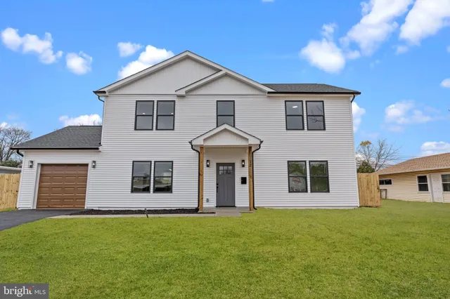 a view of a yard in front of a house with a garden