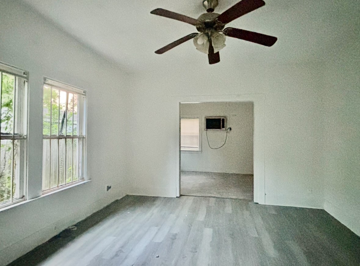 6124 Goforth Street Houston, TX 77021 - Photo 9 of 21 wooden floor in an empty room with a window