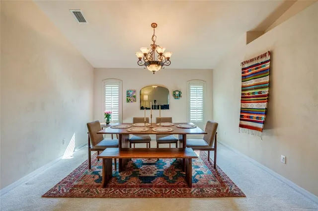 a large white kitchen with a table and chairs
