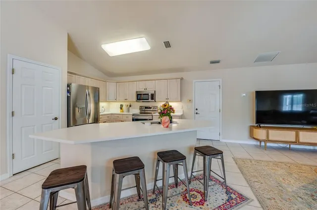 a kitchen with stainless steel appliances granite countertop a sink and cabinets