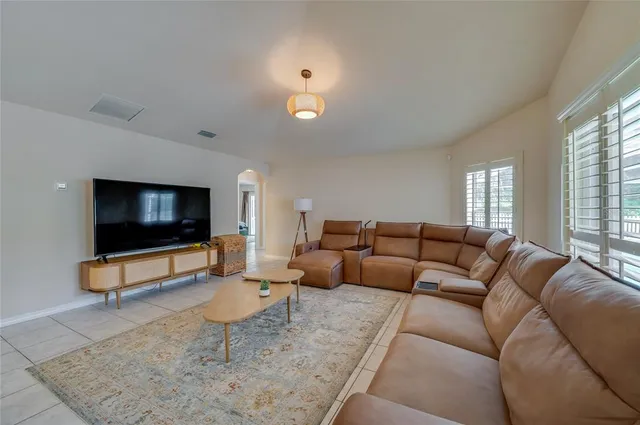 a living room with furniture and wooden floor
