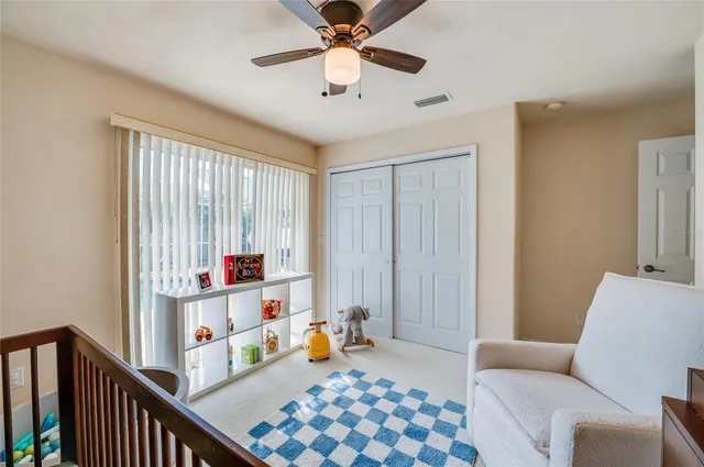 a bed sitting in a bedroom next to a window