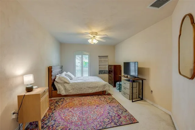 a living room with furniture a large window and a table