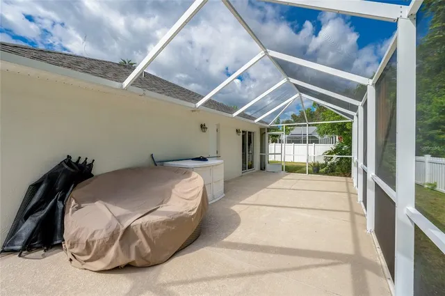 a backyard of a house with plants and large trees