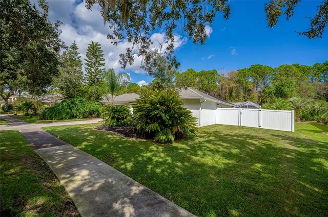 an aerial view of residential houses with outdoor space and street view