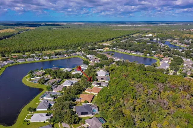an aerial view of a houses with a yard