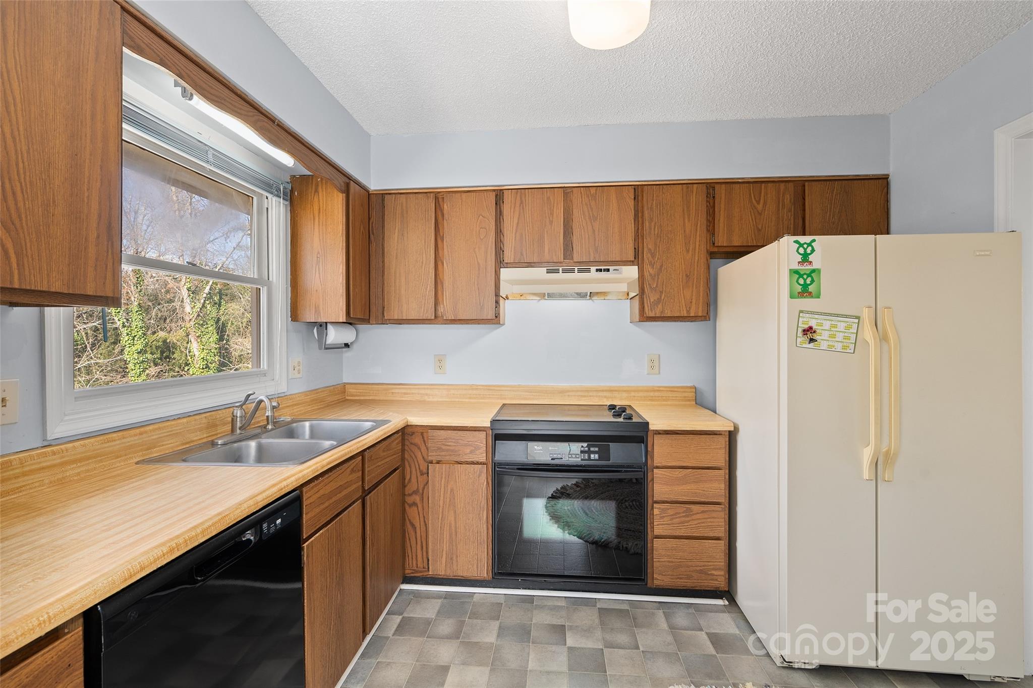 67 Overlook Road Asheville, NC 28803 - Photo 11 of 25 a kitchen with a sink a stove and a refrigerator