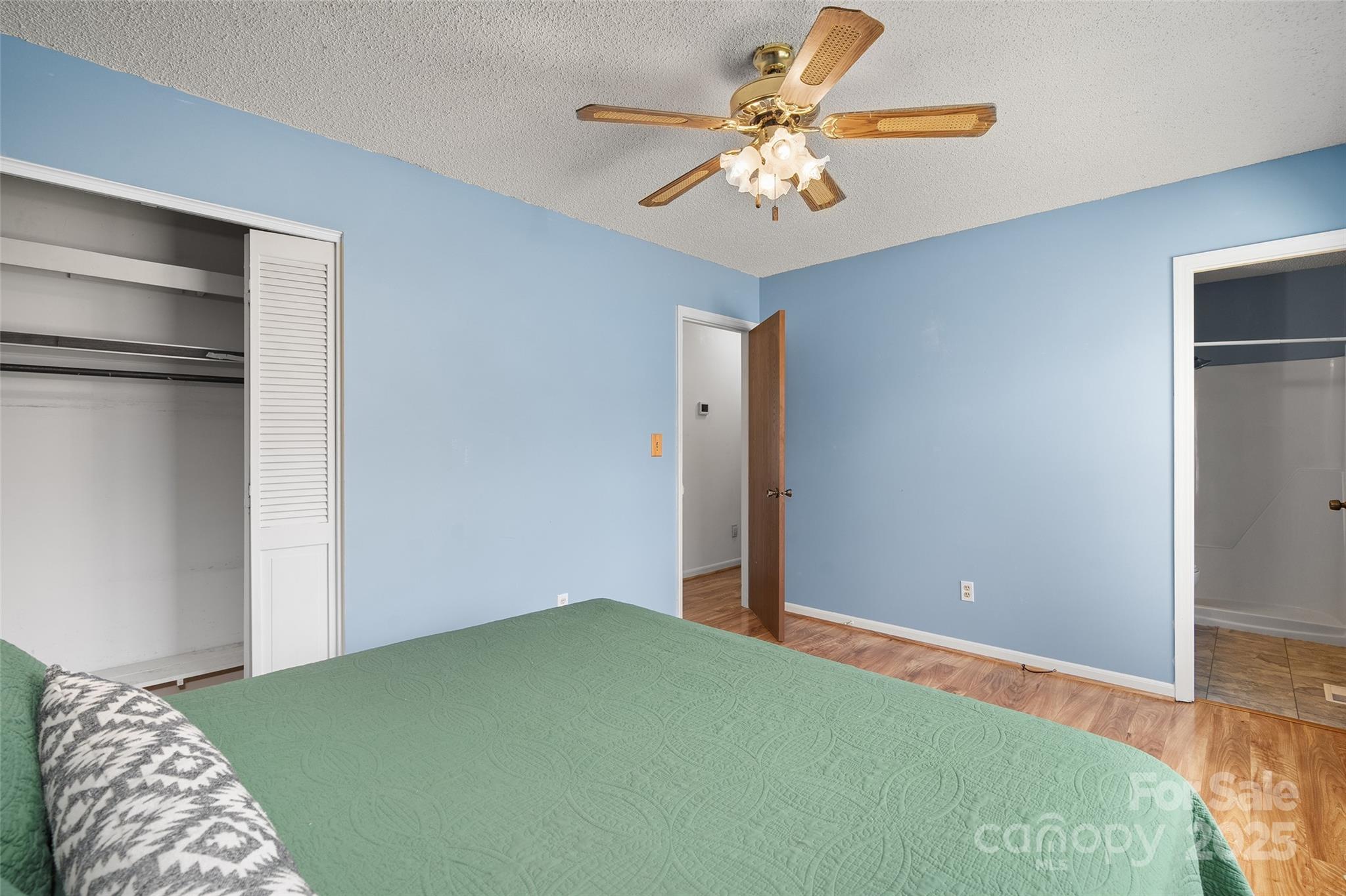 67 Overlook Road Asheville, NC 28803 - Photo 13 of 25 a bedroom with a bed and a chandelier