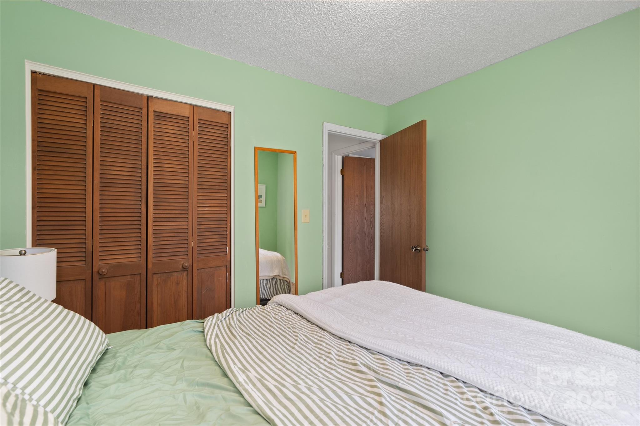 67 Overlook Road Asheville, NC 28803 - Photo 16 of 25 a bedroom with a bed and a closet