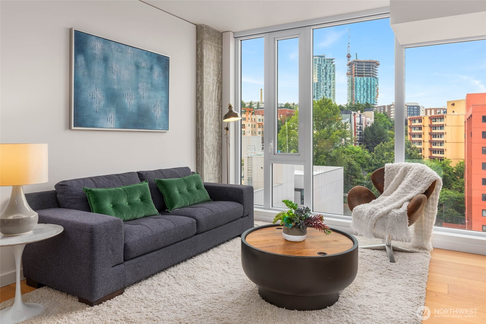 a living room with furniture and a potted plant