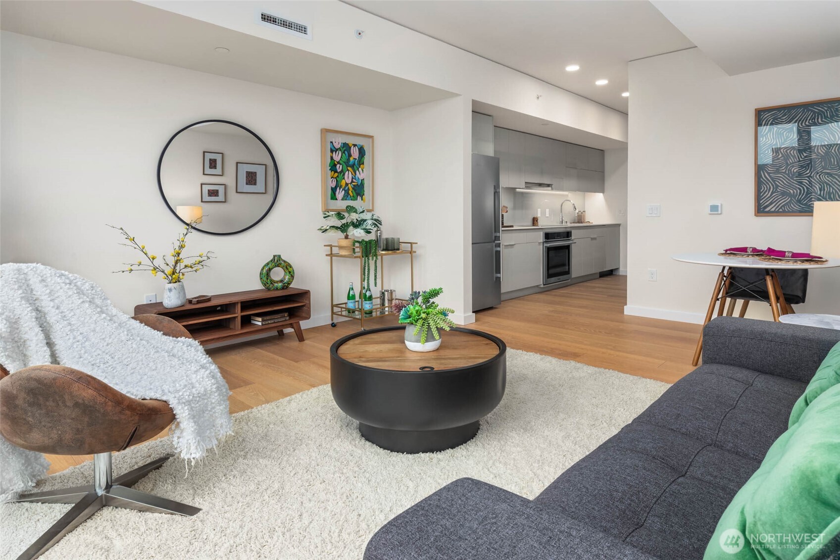 450 South Main Street, Unit 903 Seattle, WA 98104 - Photo 6 of 25 a living room with furniture and a large mirror