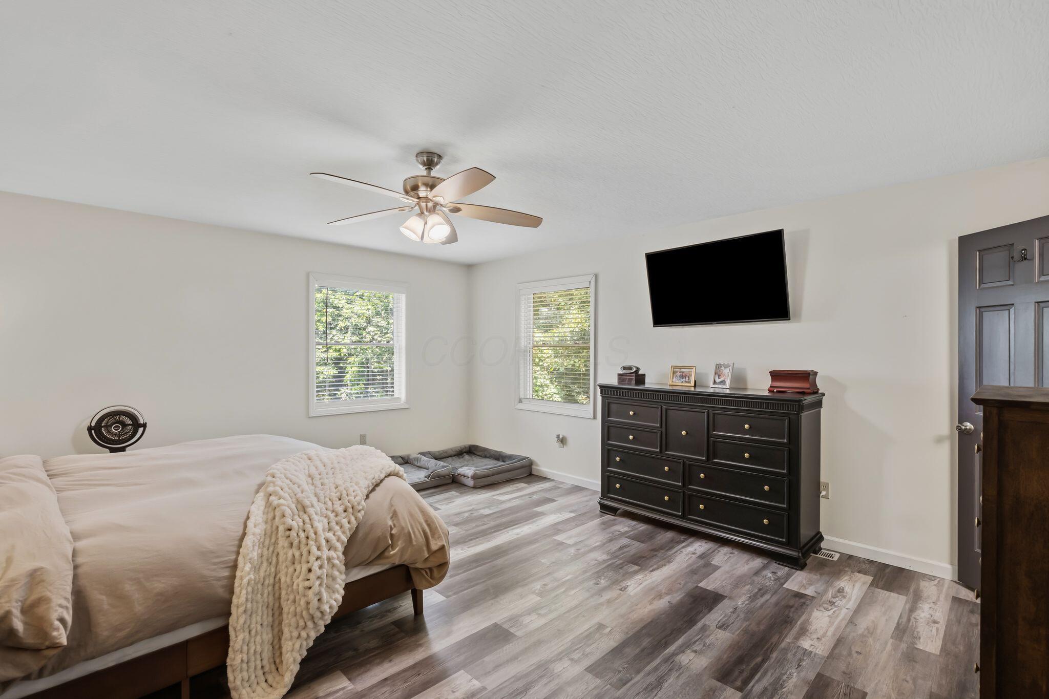 10446 Rich Hollow Road Southwest Lancaster, OH 43130 - Photo 44 of 83 Spacious room featuring wood-finish flooring, white walls, and a ceiling fan with integrated lighting