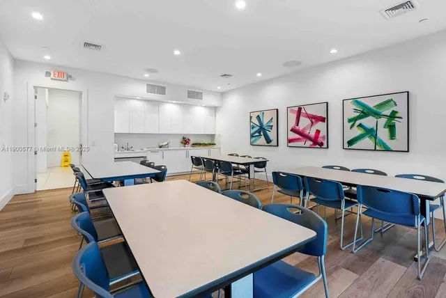 a view of a dining room with furniture kitchen and wooden floor