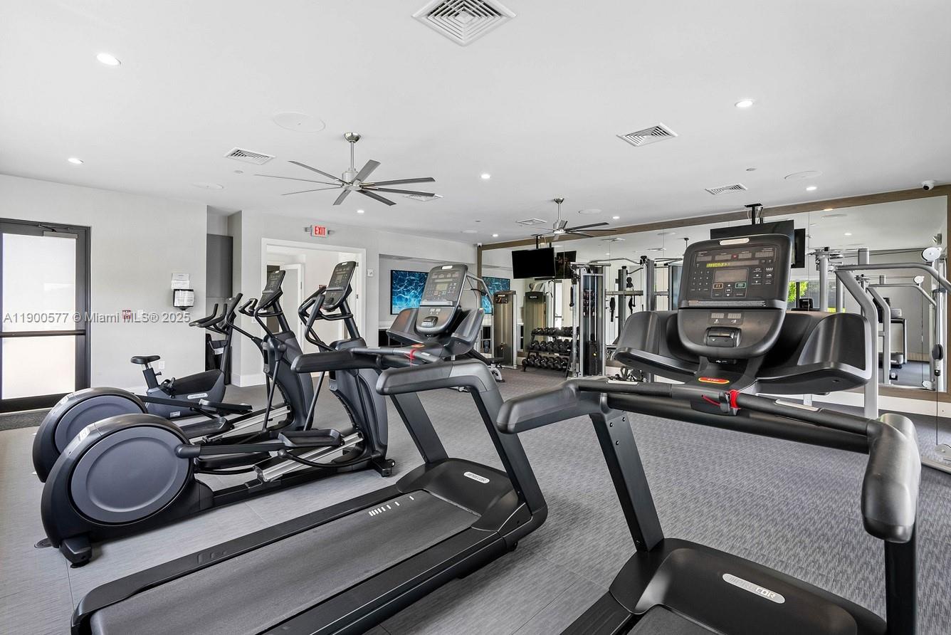 14502 Sloan Rdg Drive, Unit LUMINOSA Delray Beach, FL 33446 - Photo 12 of 49 a view of a room with gym equipment