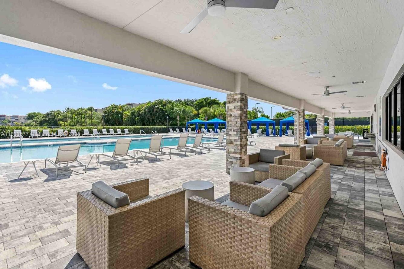14502 Sloan Rdg Drive, Unit LUMINOSA Delray Beach, FL 33446 - Photo 23 of 49 a view of a patio with couches chairs dining table and chairs