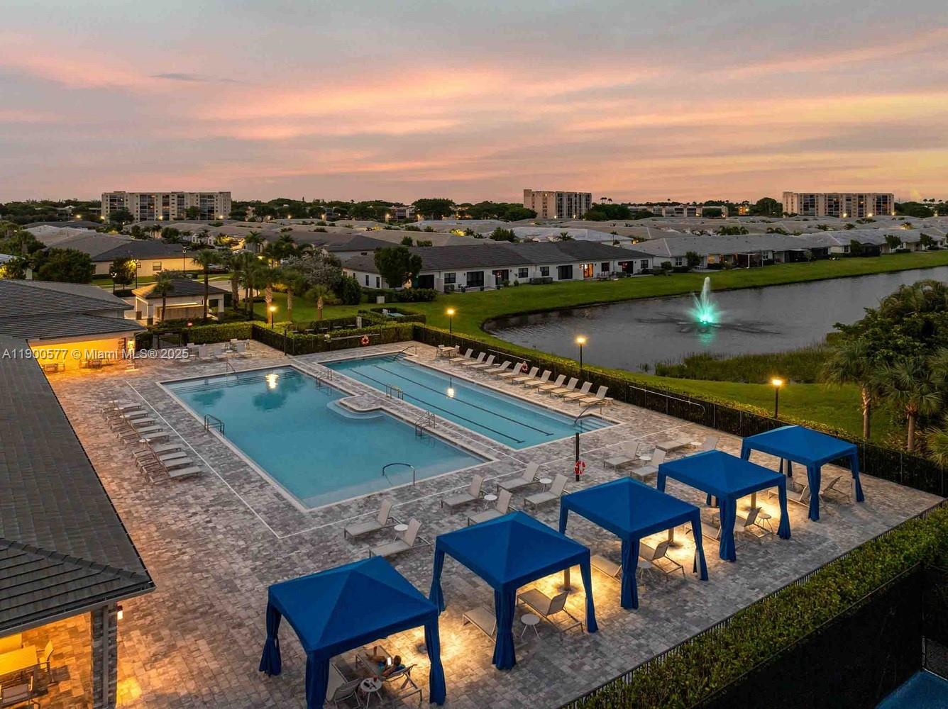 14502 Sloan Rdg Drive, Unit LUMINOSA Delray Beach, FL 33446 - Photo 26 of 49 a view of a swimming pool with a lounge chair