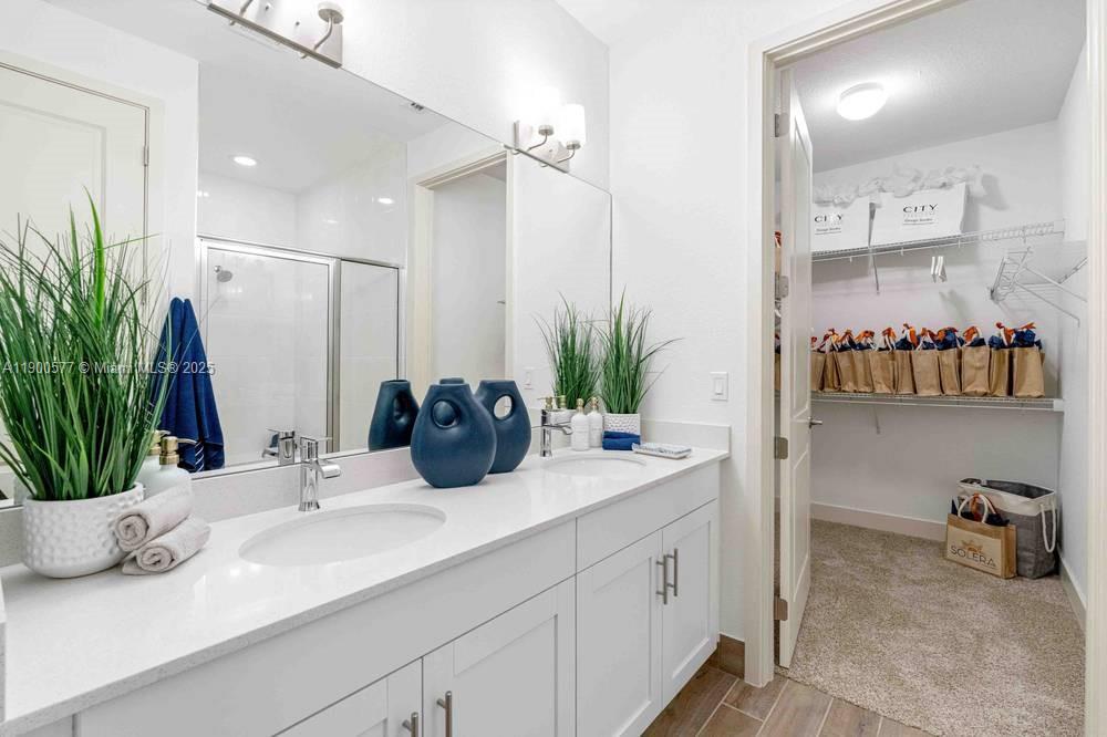 14502 Sloan Rdg Drive, Unit LUMINOSA Delray Beach, FL 33446 - Photo 47 of 49 a bathroom with a double vanity sink and a mirror