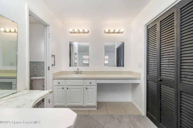 a spacious bathroom with a tub sink and mirror