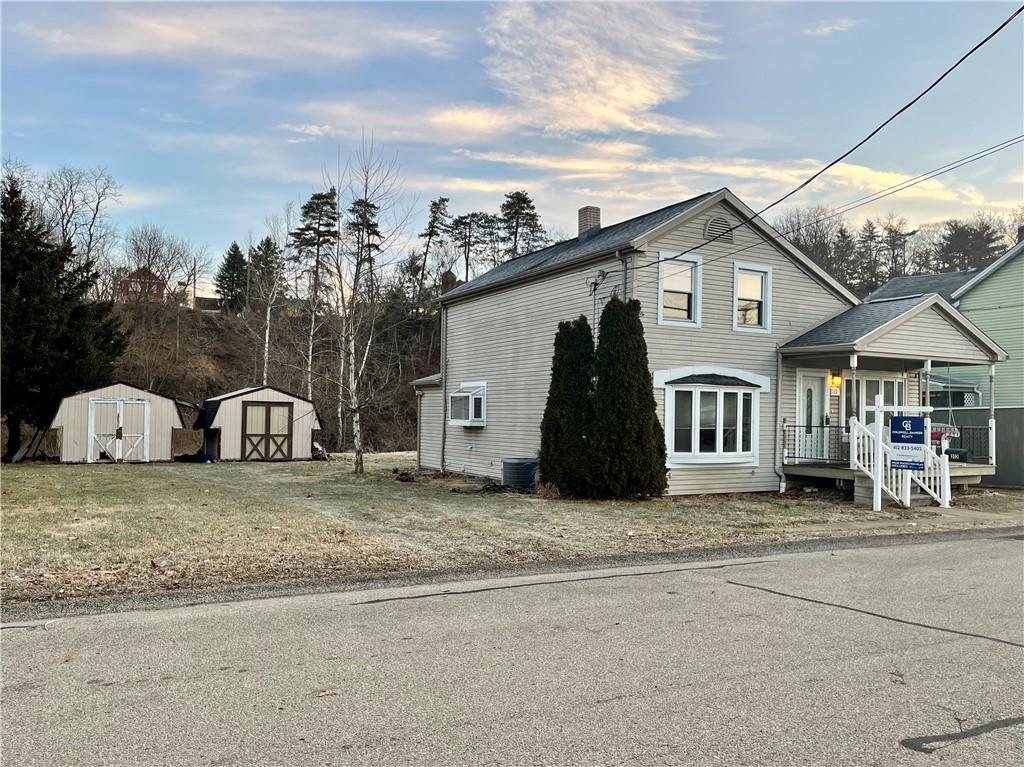 312 Zero Street Carnegie, PA 15106 - Photo 22 of 22 a view of a white house with a big yard and large trees