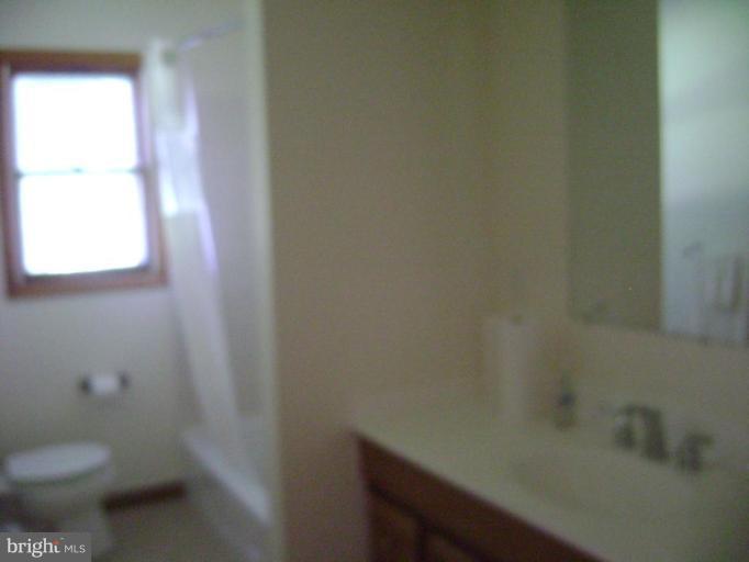 3107 Grace Road Sparrows Point, MD 21219 - Photo 4 of 7 a bathroom with a toilet and a sink