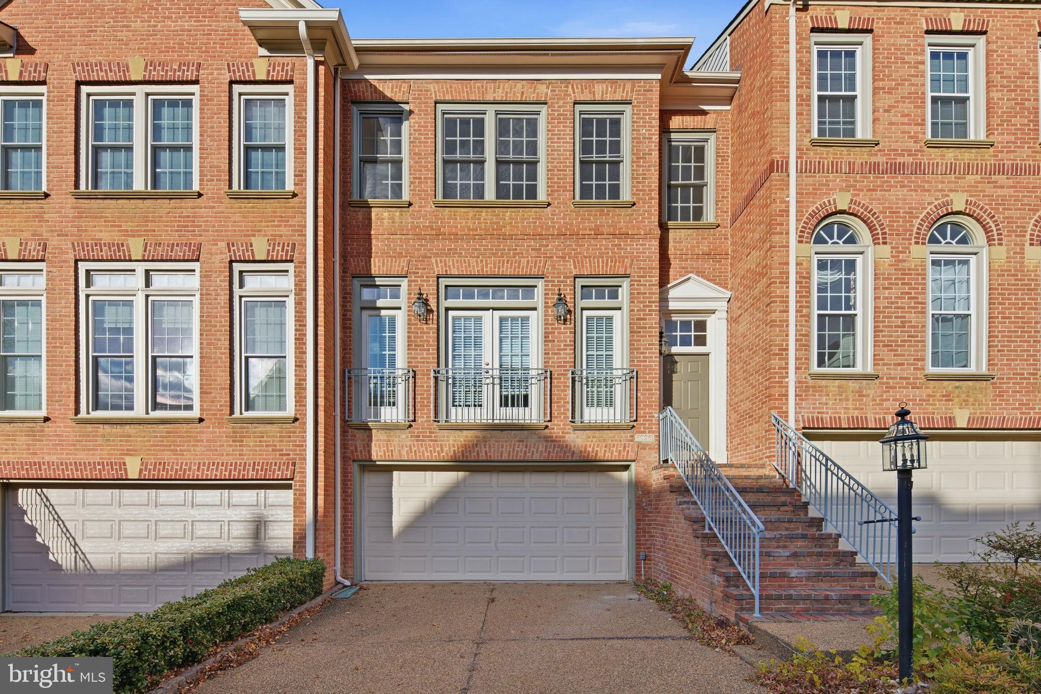 8026 Kidwell Hill Court Vienna, VA 22182 - Photo 1 of 22 a front view of a house with a garden