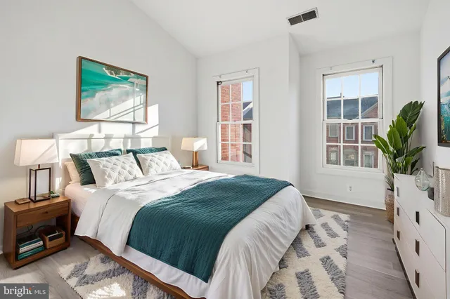 a bedroom with bed and a window