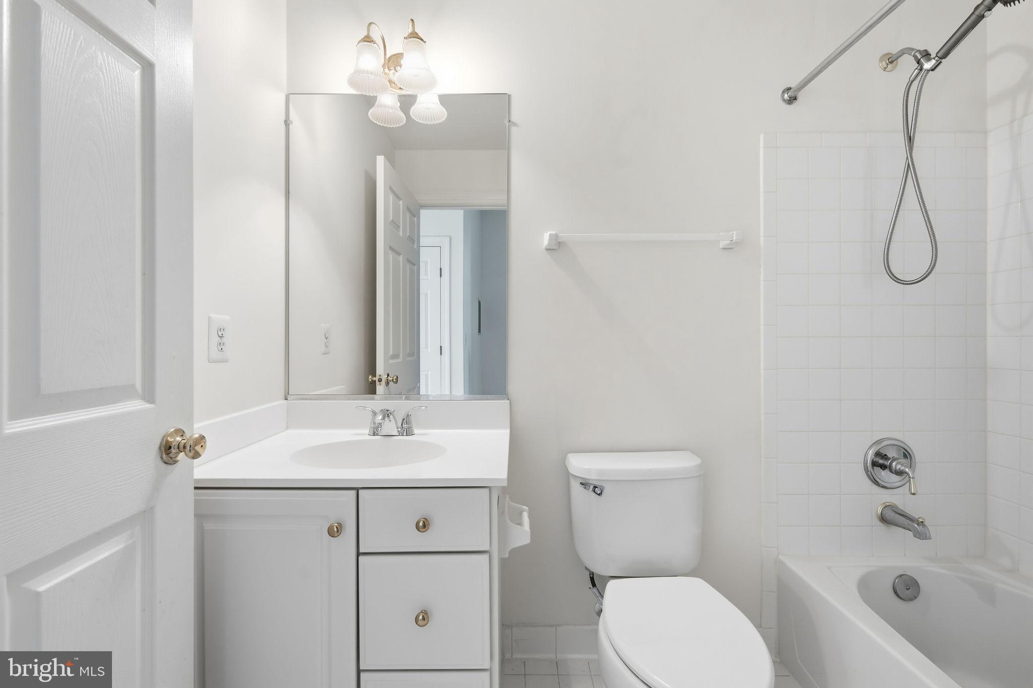 8026 Kidwell Hill Court Vienna, VA 22182 - Photo 17 of 22 a bathroom with a toilet sink vanity granite and shower