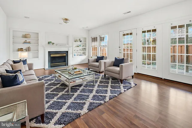 a living room with furniture a rug and a fireplace