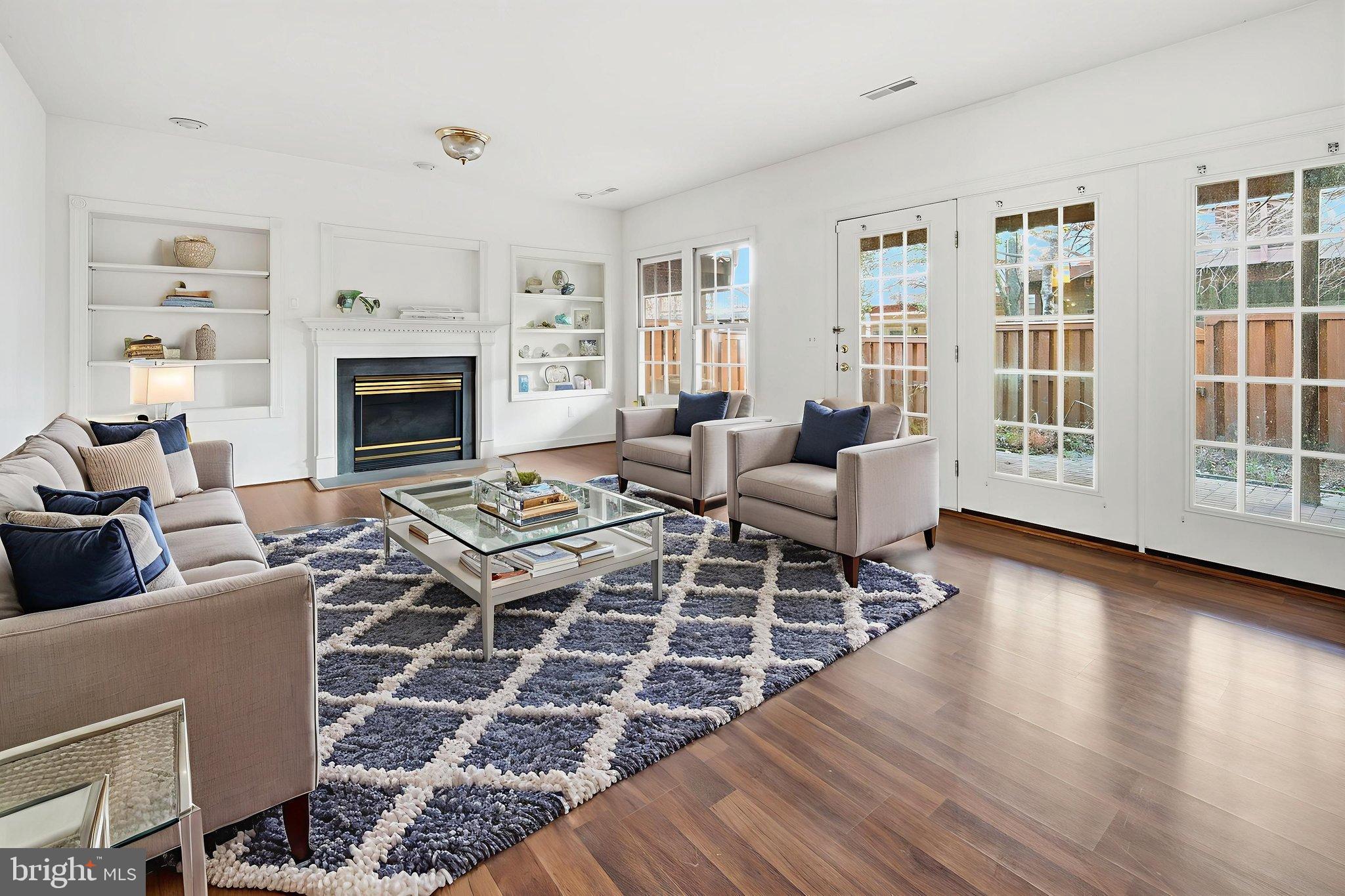 8026 Kidwell Hill Court Vienna, VA 22182 - Photo 18 of 22 a living room with furniture a rug and a fireplace