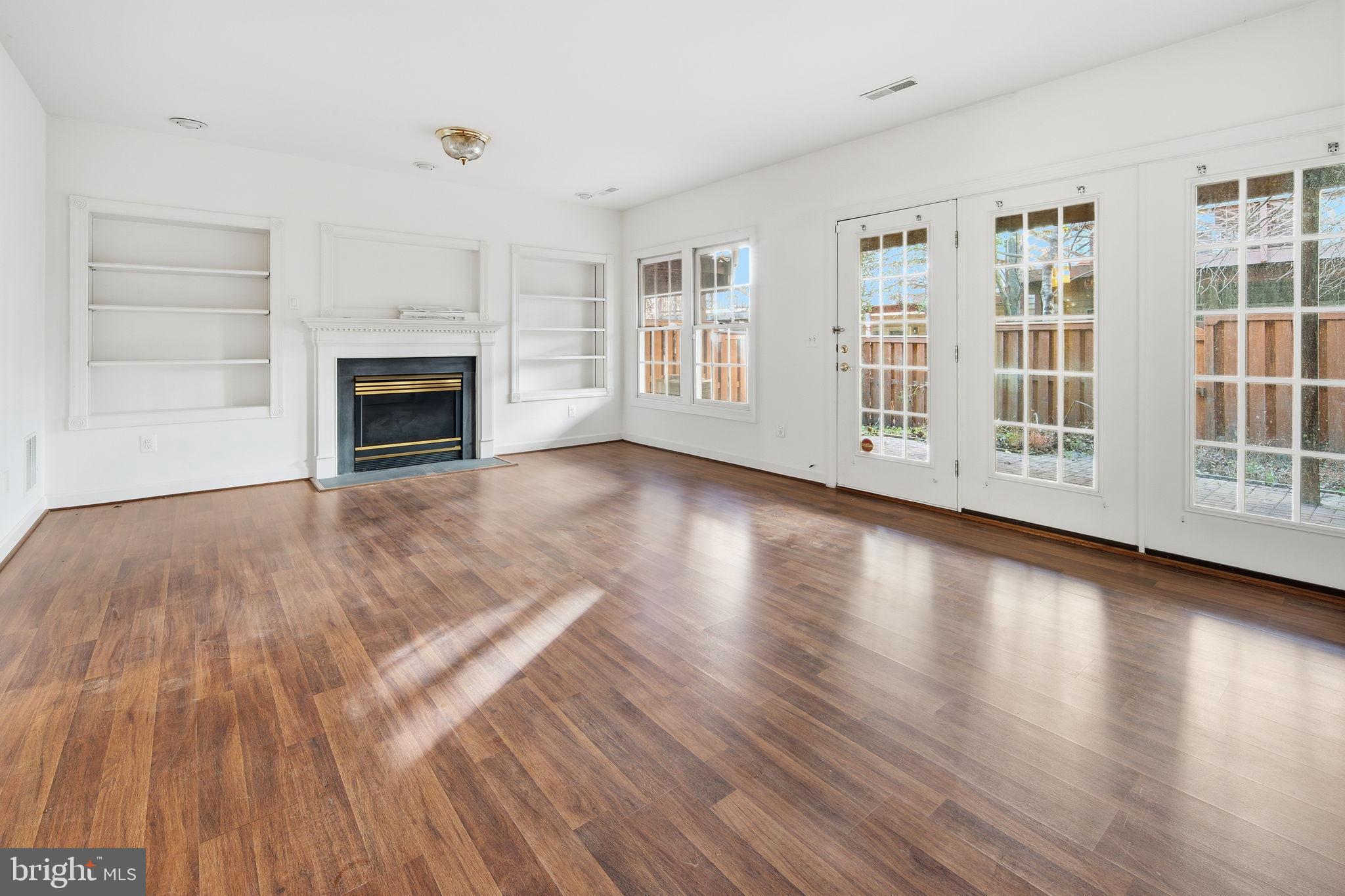8026 Kidwell Hill Court Vienna, VA 22182 - Photo 19 of 22 a view of empty room with wooden floor and fireplace