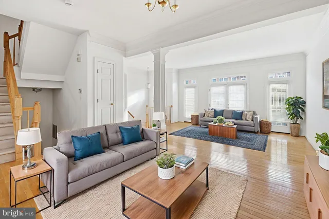 a living room with furniture or kitchen view and a wooden floor