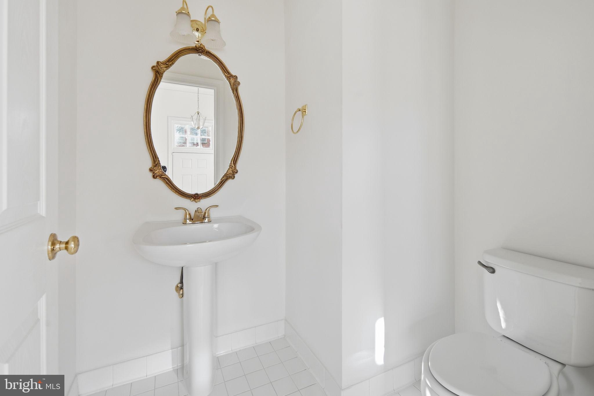 8026 Kidwell Hill Court Vienna, VA 22182 - Photo 4 of 22 a bathroom with a toilet and a sink