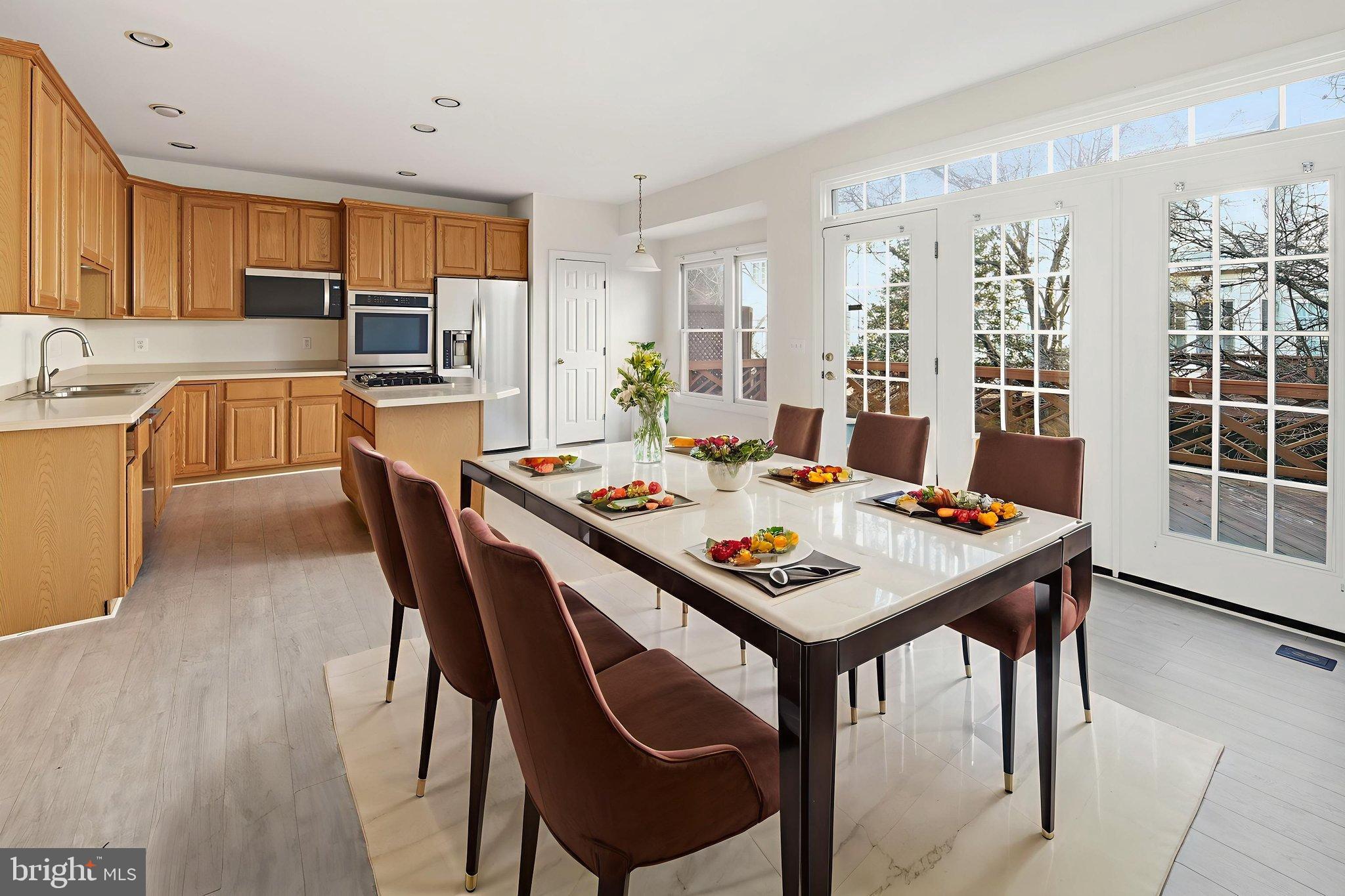 8026 Kidwell Hill Court Vienna, VA 22182 - Photo 7 of 22 a view of a dining room with furniture and wooden floor