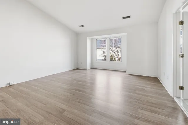 a view of room with wooden floor and window