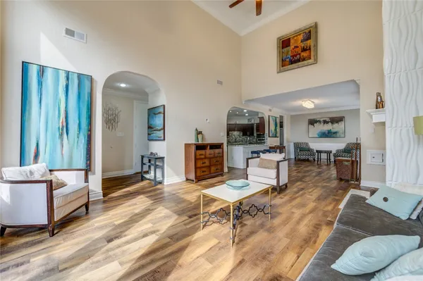 a living room with furniture and kitchen view