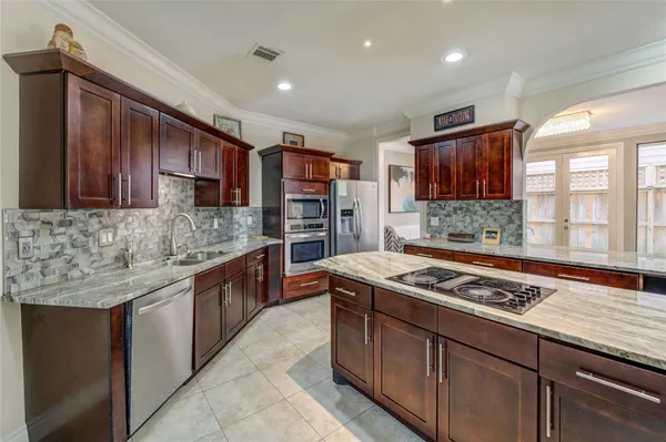 a kitchen with stainless steel appliances granite countertop a stove sink and cabinets