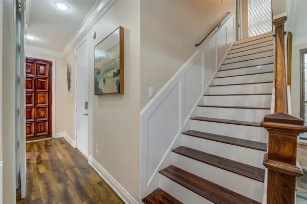 a view of entryway with wooden floor and stairs