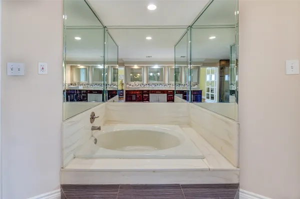 a bathroom with a bathtub and shower