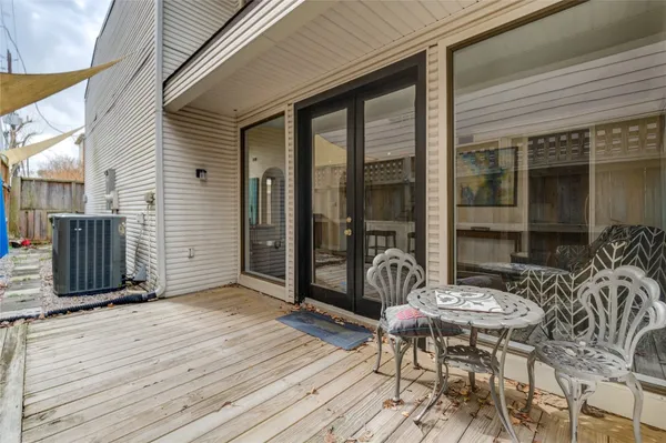 a view of a patio with table and chairs and wooden floor