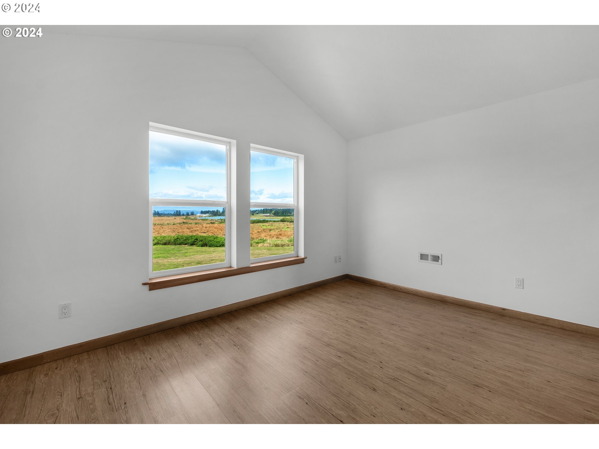 90713 Fort Clatsop Road Astoria, OR 97103 - Photo 20 of 30 a view of an empty room with a window and wooden floor