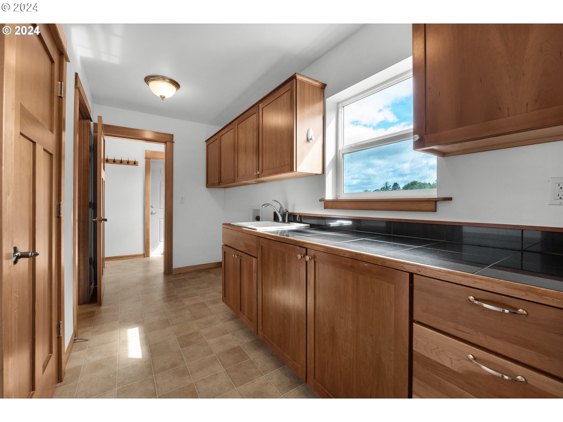 90713 Fort Clatsop Road Astoria, OR 97103 - Photo 21 of 30 a kitchen with kitchen island granite countertop a sink cabinets and stainless steel appliances