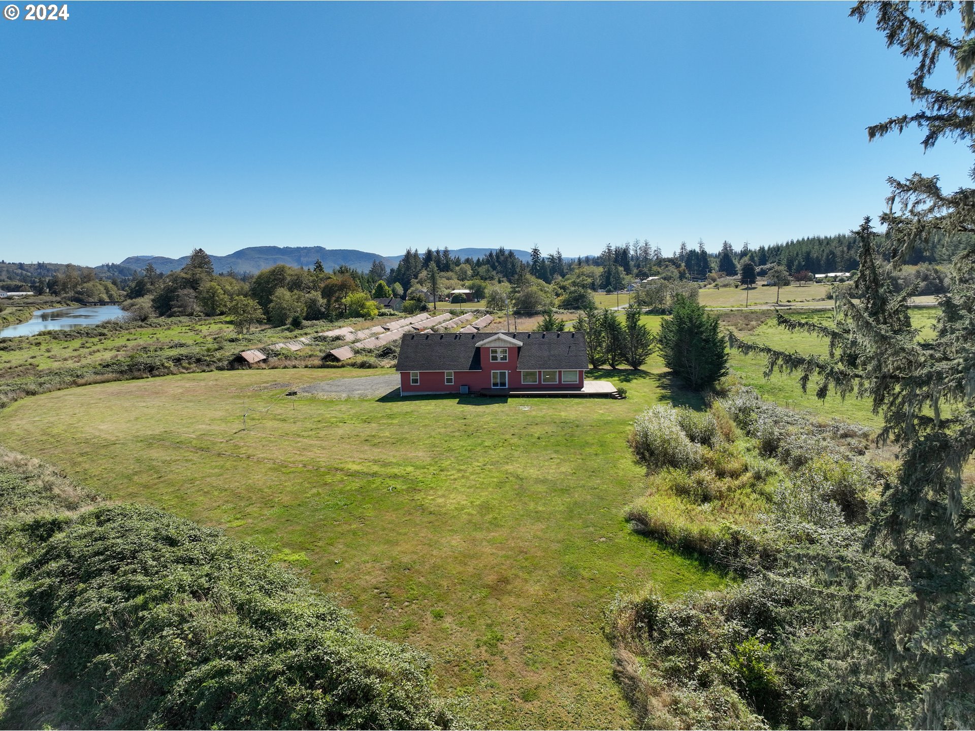 90713 Fort Clatsop Road Astoria, OR 97103 - Photo 23 of 30 a view of lake with houses in the background