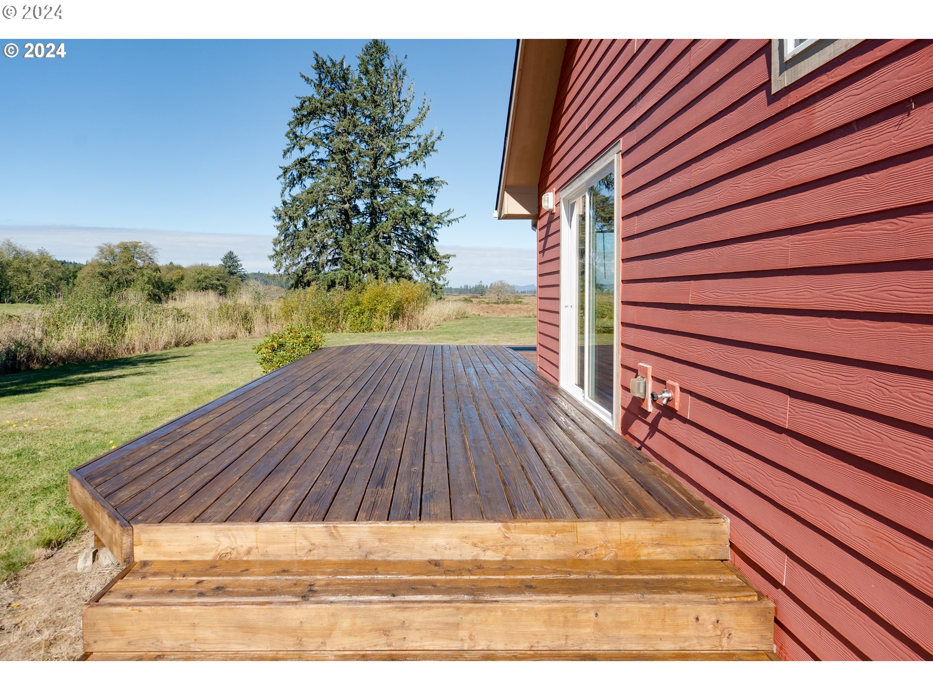 90713 Fort Clatsop Road Astoria, OR 97103 - Photo 26 of 30 a view of backyard with wooden floor and a potted plant