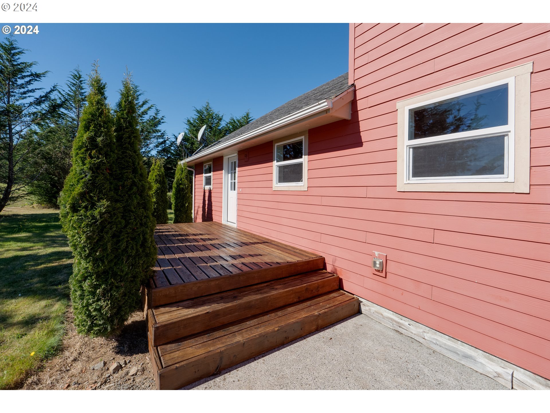 90713 Fort Clatsop Road Astoria, OR 97103 - Photo 4 of 30 a view of a wooden chairs in a yard