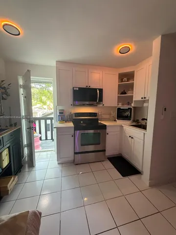 a kitchen with stainless steel appliances a stove a sink and a refrigerator