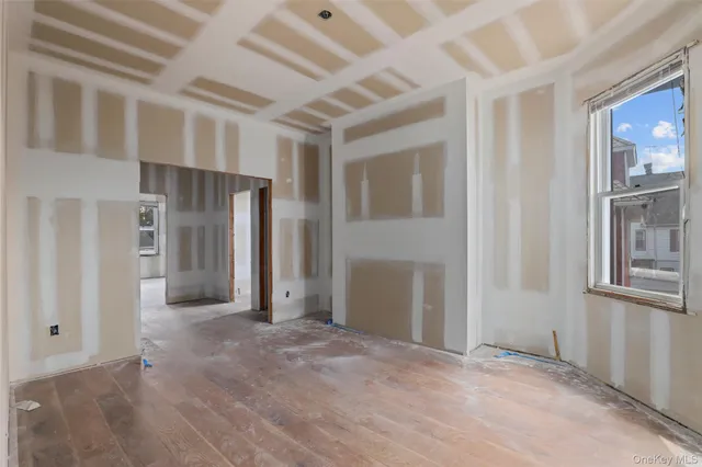 a view of a hallway with wooden shelves